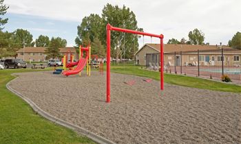 Secondary view of the outdoor community playground with the outdoor pool in the background.
